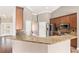 Kitchen featuring granite countertops, stainless steel appliances and bar seating at 234 Locust Pass Loop, Ocala, FL 34472