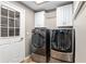 The laundry room features modern appliances, overhead cabinets, and access to the backyard at 234 Locust Pass Loop, Ocala, FL 34472