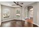 Open living room with neutral walls, wood flooring, and arched entryways, providing ample natural light at 234 Locust Pass Loop, Ocala, FL 34472