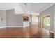 Open-concept living room with hardwood floors and sliding glass doors to the backyard at 234 Locust Pass Loop, Ocala, FL 34472