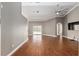Spacious living room featuring hardwood floors, a ceiling fan, and sliding glass doors to the backyard at 234 Locust Pass Loop, Ocala, FL 34472