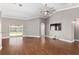 Bright living room with hardwood floors, a ceiling fan, and sliding glass doors to the backyard at 234 Locust Pass Loop, Ocala, FL 34472