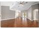 Open-concept living room with hardwood floors and sliding glass doors to the backyard at 234 Locust Pass Loop, Ocala, FL 34472