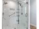 Updated glass enclosed shower has marble tile and shelving at 234 Locust Pass Loop, Ocala, FL 34472