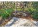 A tranquil backyard pond adds a serene touch to the outdoor space and is a perfect retreat at 3060 Ne 35Th St, Ocala, FL 34479