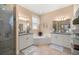 Elegant bathroom with dual sinks, granite countertops, a soaking tub, and a glass-enclosed shower at 3060 Ne 35Th St, Ocala, FL 34479