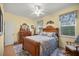 Bright bedroom featuring yellow walls, a wooden bed with patterned bedding, and large windows at 3060 Ne 35Th St, Ocala, FL 34479