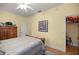 Bedroom featuring wood furniture, yellow walls, and a doorway to a storage area at 3060 Ne 35Th St, Ocala, FL 34479