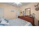 Comfortable bedroom featuring a wooden dresser, bright walls, and a mounted deer head at 3060 Ne 35Th St, Ocala, FL 34479