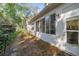 The back of the house is visible showing an enclosed porch with several windows at 3060 Ne 35Th St, Ocala, FL 34479