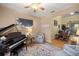 Elegant living room featuring a grand piano, soft lighting, and an ornate rug at 3060 Ne 35Th St, Ocala, FL 34479