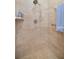 Detailed close up of the shower with tan tile and mounted shower head at 3060 Ne 35Th St, Ocala, FL 34479