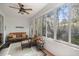 Relax in the bright sunroom featuring lots of windows and comfortable wicker furnishings at 3060 Ne 35Th St, Ocala, FL 34479