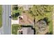 Aerial view of a home showcases the roof, driveway, and surrounding neighborhood with mature trees at 3321 Woodridge Dr, The Villages, FL 32162