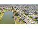Aerial view of a well-planned residential area near a serene lake and vibrant green spaces at 3321 Woodridge Dr, The Villages, FL 32162