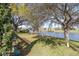 Lush backyard overlooking a serene lake at 3321 Woodridge Dr, The Villages, FL 32162