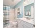 Charming bathroom with a shower-tub combo, a bright mirror, a white vanity, and tasteful decor at 3321 Woodridge Dr, The Villages, FL 32162