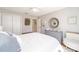 Bright bedroom with a closet, a decorative mirror, comfortable bed, stylish linens, and natural light at 3321 Woodridge Dr, The Villages, FL 32162