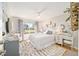 Inviting bedroom features a large window, stylish rug, comfortable bed, and a vanity with natural light at 3321 Woodridge Dr, The Villages, FL 32162