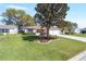 Charming single-story home with a well-manicured lawn and a delightful landscape bedded tree at 3321 Woodridge Dr, The Villages, FL 32162