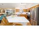 Spacious kitchen features stainless steel appliances, wood cabinets, stone countertops, and adjacent breakfast area at 3321 Woodridge Dr, The Villages, FL 32162