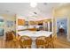 Bright eat-in kitchen with stainless steel appliances, wooden cabinets, white countertops, and access to the bedroom at 3321 Woodridge Dr, The Villages, FL 32162