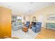Cozy living room featuring vaulted ceilings, a ceiling fan, and comfortable seating arrangement with lots of natural light at 3321 Woodridge Dr, The Villages, FL 32162