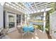 Outdoor patio with a white pergola, dining furniture, and serene lake views at 3321 Woodridge Dr, The Villages, FL 32162
