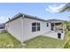 Back exterior view of a home with a screened in lanai and tropical landscaping at 3472 Jaguar Ct, The Villages, FL 32163