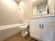 Well-lit bathroom featuring a shower-tub combination, a white vanity and wood-look tile floors at 3628 Sw 133Rd Loop, Ocala, FL 34473