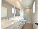 Bathroom featuring a double vanity, large mirror and glass enclosed shower at 3628 Sw 133Rd Loop, Ocala, FL 34473