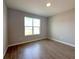 Bedroom with tile floors and a large window with backyard view at 3628 Sw 133Rd Loop, Ocala, FL 34473