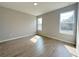 Sun-filled bedroom with wood-look tile flooring and large windows at 3628 Sw 133Rd Loop, Ocala, FL 34473