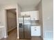 Modern kitchen with stainless steel refrigerator and white cabinets and countertops at 3628 Sw 133Rd Loop, Ocala, FL 34473