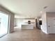 Open concept kitchen with modern white cabinets, island, and stainless steel appliances at 3628 Sw 133Rd Loop, Ocala, FL 34473