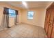 Bright bedroom with tile flooring, natural light from two windows, and a spacious closet at 3702 Sw 148Th Pl, Ocala, FL 34473