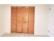 Bedroom closet with light wood-colored bi-fold doors at 3702 Sw 148Th Pl, Ocala, FL 34473