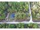Aerial view of home nestled in lush woods along a dirt road at 3896 Sw 177Th Ter, Dunnellon, FL 34432