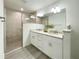 Bathroom featuring a glass shower, double vanity with granite counters, and modern fixtures at 3896 Sw 177Th Ter, Dunnellon, FL 34432
