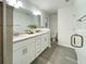 Bright bathroom featuring double sinks with granite countertops, gray wood-look flooring, and toilet at 3896 Sw 177Th Ter, Dunnellon, FL 34432