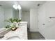 Bright bathroom featuring double sinks with granite countertops and gray wood-look flooring at 3896 Sw 177Th Ter, Dunnellon, FL 34432