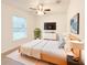 Bedroom with neutral decor, a ceiling fan, and a large window overlooking a lush backyard at 3896 Sw 177Th Ter, Dunnellon, FL 34432