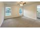 Cozy bedroom with plush carpeting, bright windows, and neutral paint at 3896 Sw 177Th Ter, Dunnellon, FL 34432