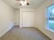 Bedroom with neutral carpet, a ceiling fan, a double closet, and a large window at 3896 Sw 177Th Ter, Dunnellon, FL 34432