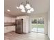 Open dining area featuring wood-look floors, sliding glass doors, and updated appliances at 3896 Sw 177Th Ter, Dunnellon, FL 34432