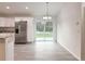 Open dining area featuring wood-look floors, sliding glass doors, and chandelier lighting at 3896 Sw 177Th Ter, Dunnellon, FL 34432