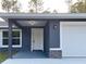 Inviting entryway with a white front door, stone accents, and attached garage at 3896 Sw 177Th Ter, Dunnellon, FL 34432