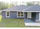 Charming single-story home with a gray facade, dark roof, and manicured lawn at 3896 Sw 177Th Ter, Dunnellon, FL 34432