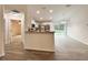Open-concept kitchen boasts white cabinets, granite countertops, and stainless steel appliances at 3896 Sw 177Th Ter, Dunnellon, FL 34432