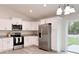 Modern kitchen featuring white cabinets, granite counters, and stainless steel appliances at 3896 Sw 177Th Ter, Dunnellon, FL 34432